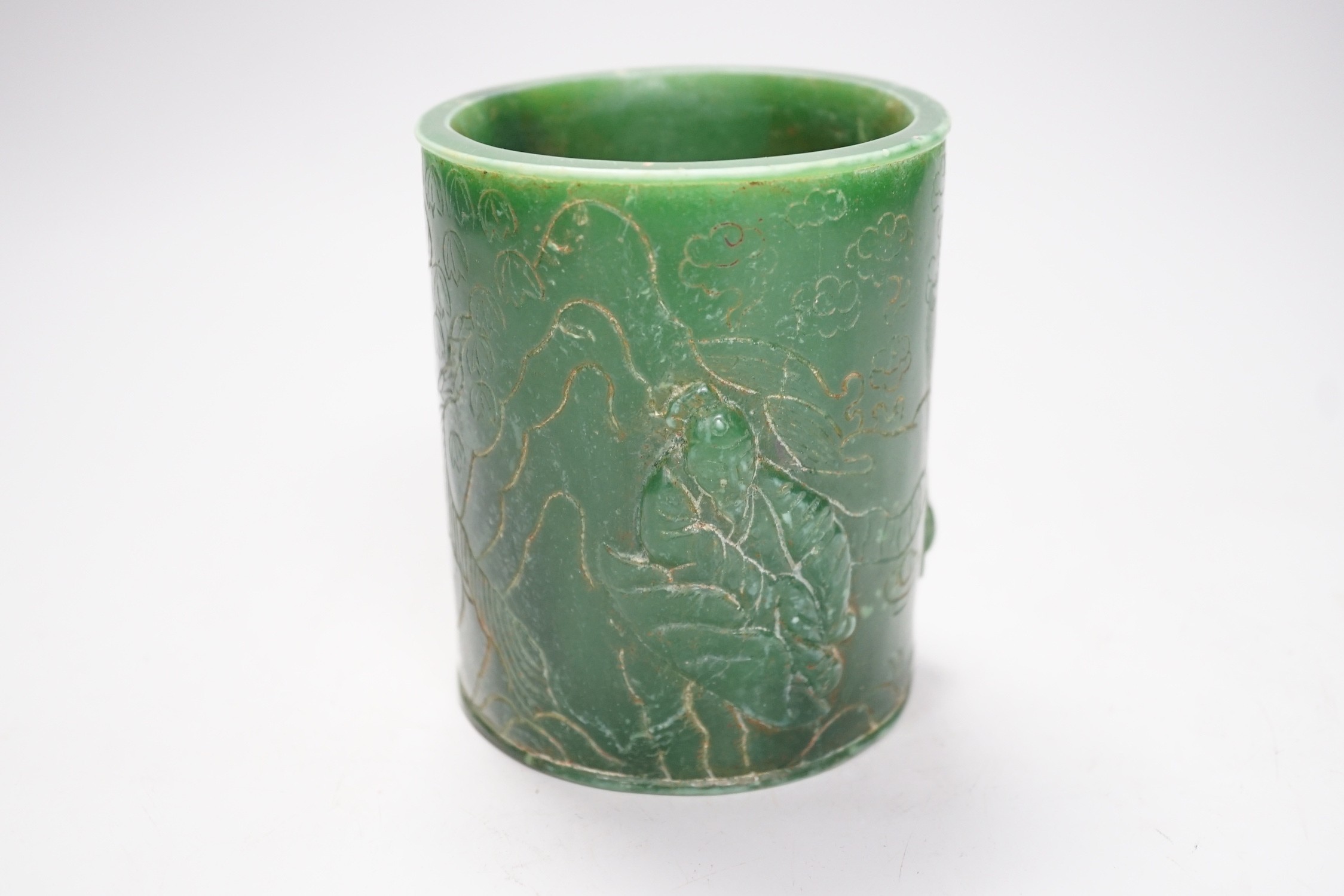 A Chinese incised green glass cylindrical brushpot, 11cm